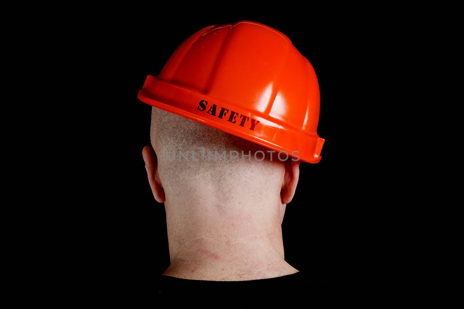 Construction worker in hard hat with an inscription safety on gray background