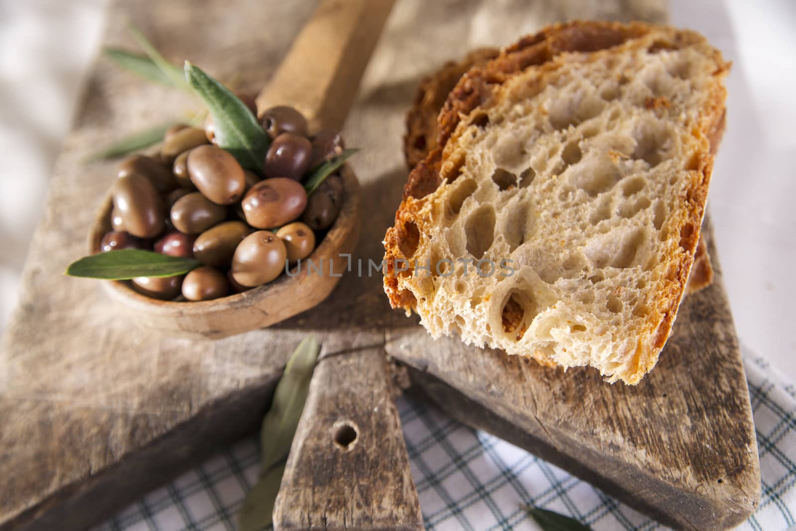 Snack of slice of bread with olives in brine