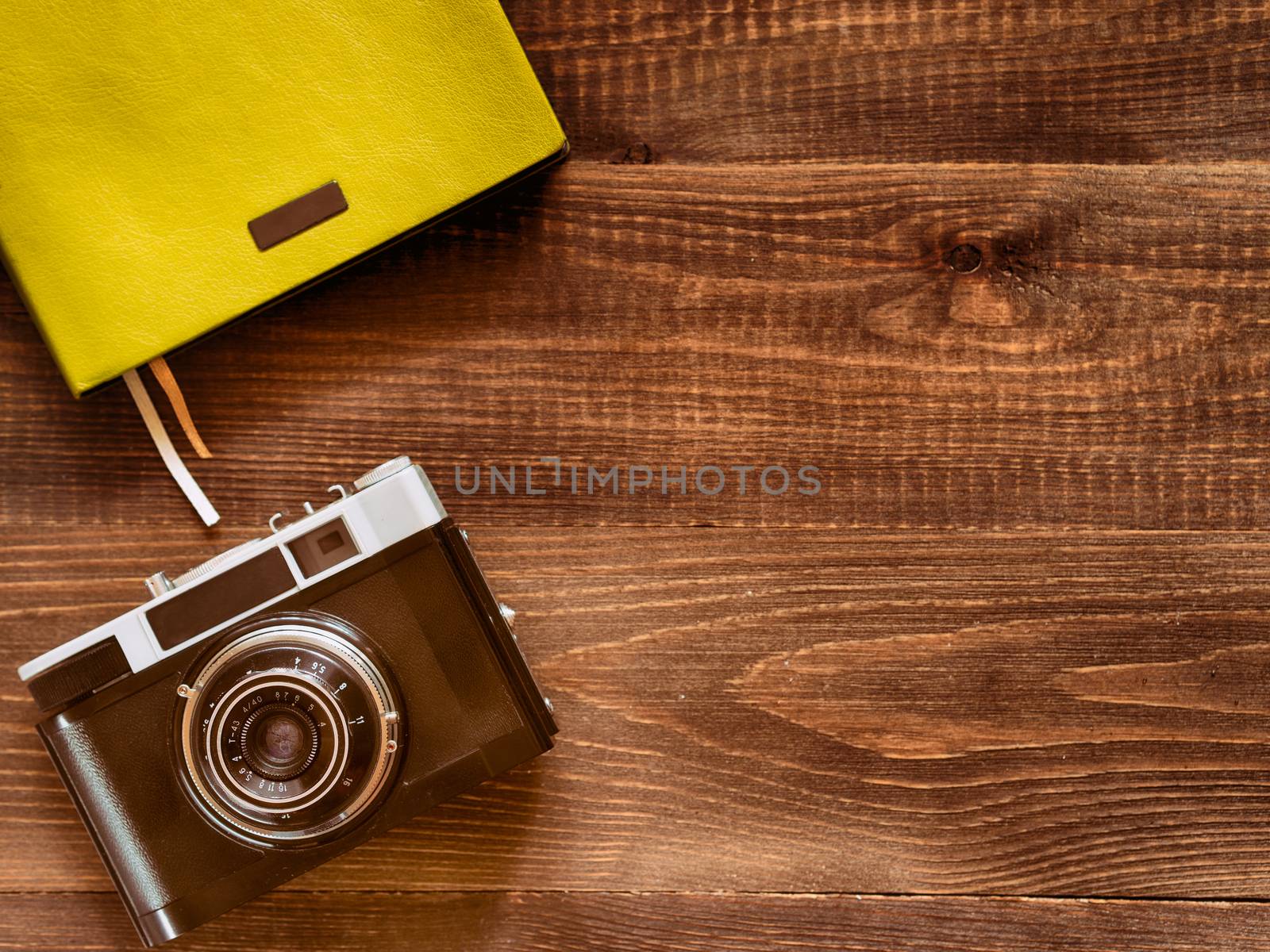 top view vintage old camera and notebook on wooden background by fascinadora