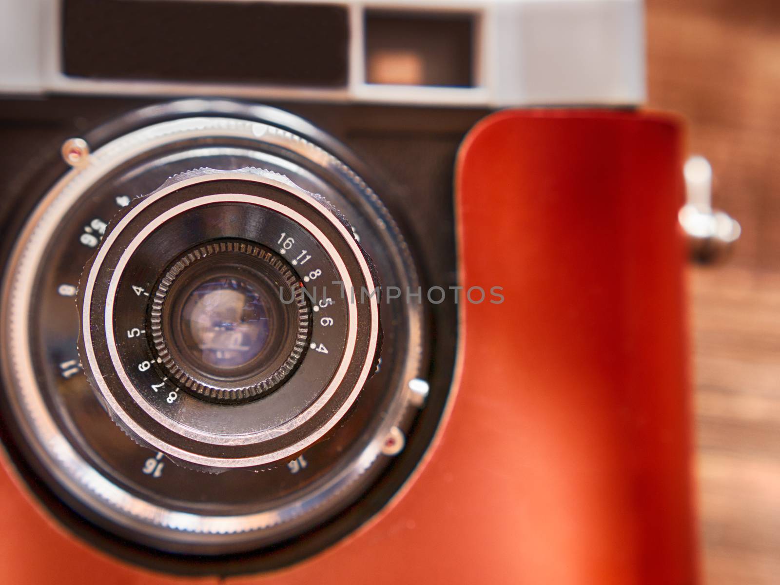 close up photo of old vintage camera lens over wooden table. selective focus