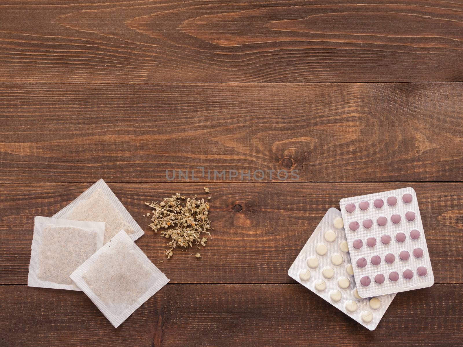 Herbal medicine and Chemical medicine on wooden background by fascinadora