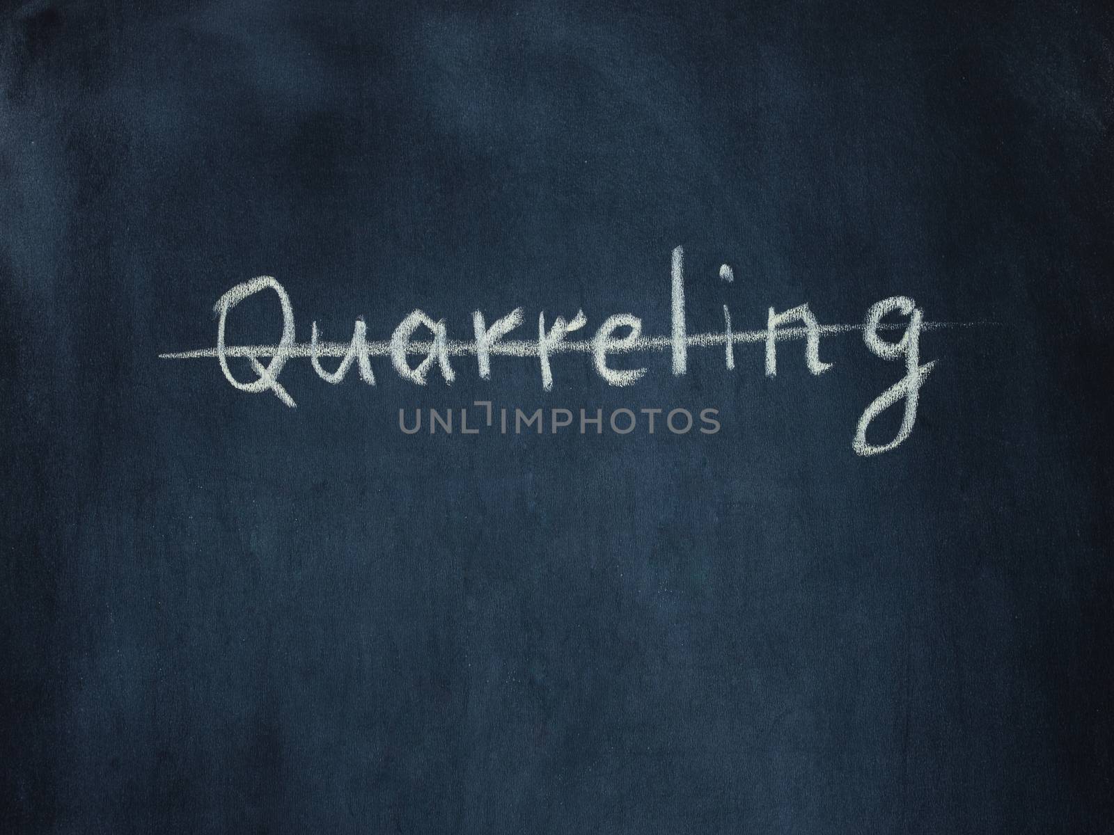 crossed out the word Quarreling on black chalkboard by fascinadora