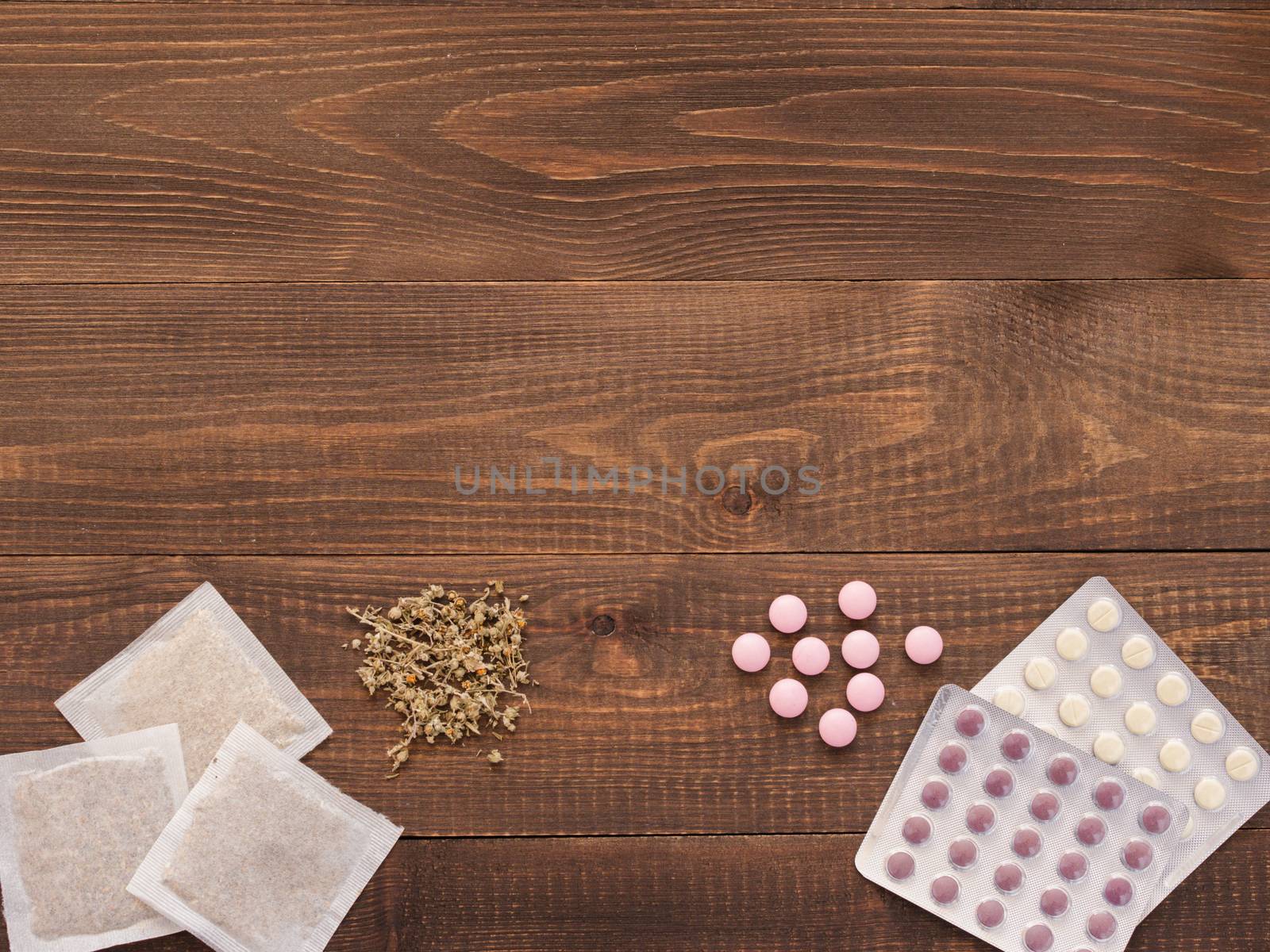 tablets and herbals on a dark wooden background with copy space. Herbal medicine VS Chemical medicine the alternative healthy care. Flat lay or top view