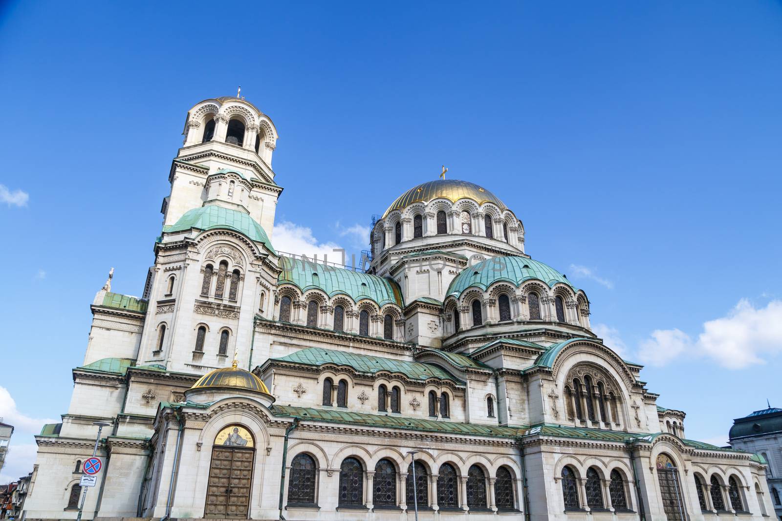 General bottom view of famous Bulgarian Orthodox church of Alexander Nevsky Cathedral built in 1882 in Sofia, Bulgaria, on blue sky background.