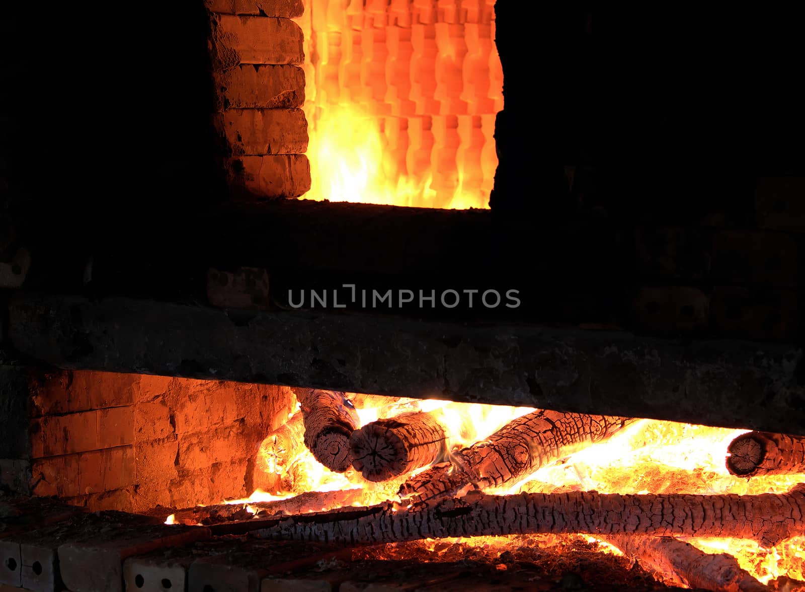 Brickwork with firewood is burning in red, make exhaust fumes when use firewood to burn, CO2 make pollution environment, Vietnam