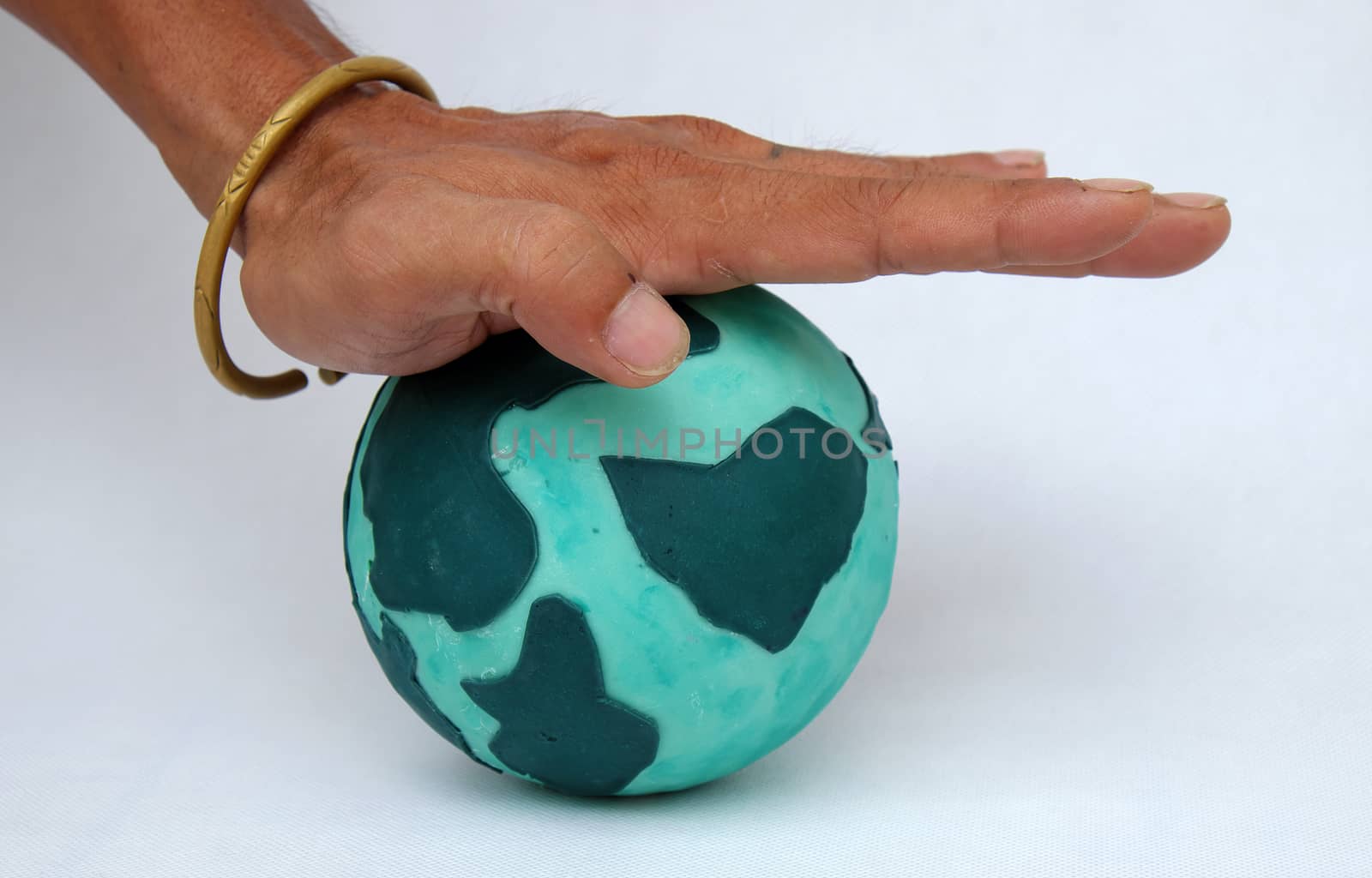 Concept for destroy the earth by human hand on white background, human ruin green planet, is worldwide problem, can make climate change, disaster, damaged environment