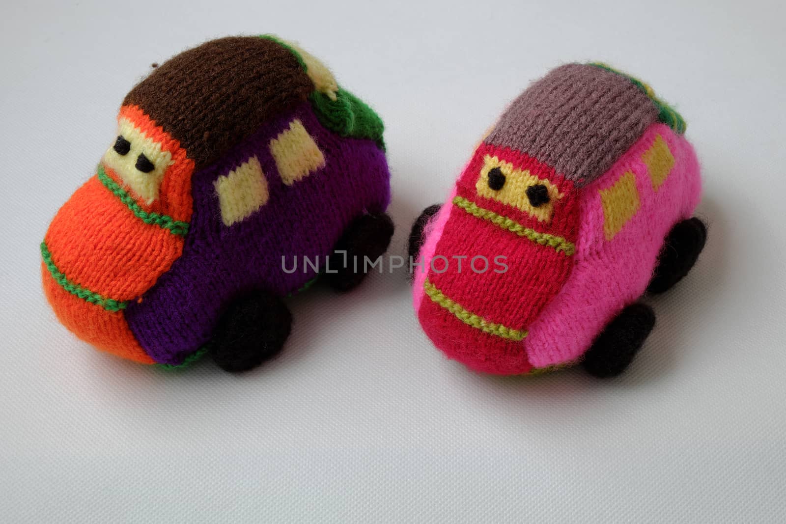 Handmade gift for children, two colorful baby car knit from yarn, funny emotion on couple car, homemade toy as amazing present