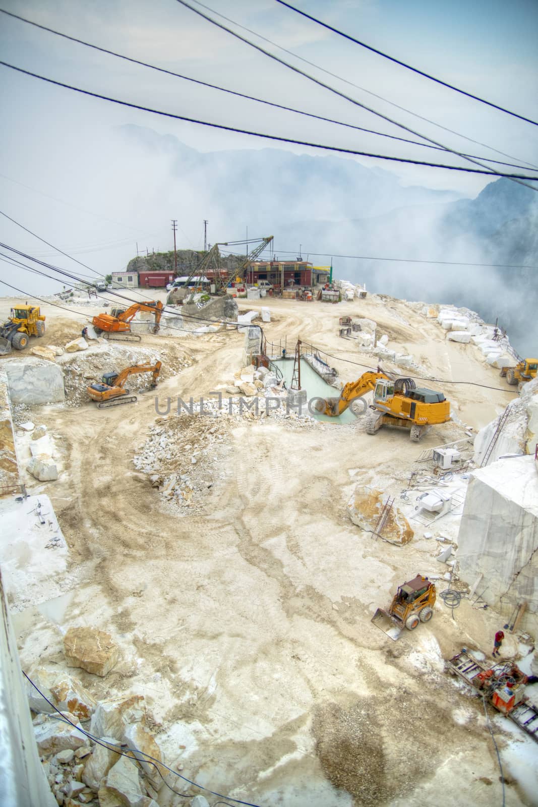 Broad view of the process in the white marble quarries in Carrara Italy