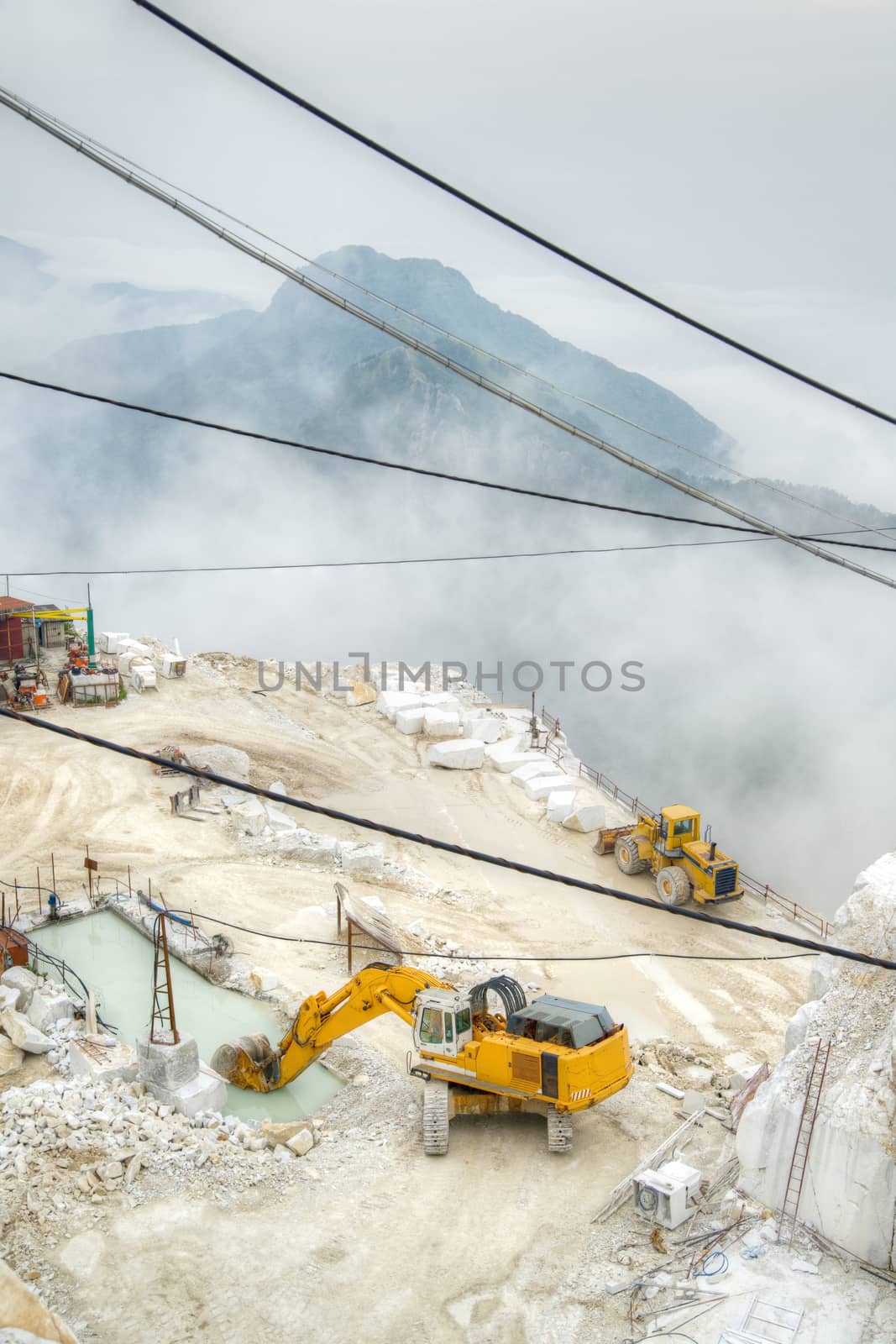 Broad view of the process in the white marble quarries in Carrara Italy