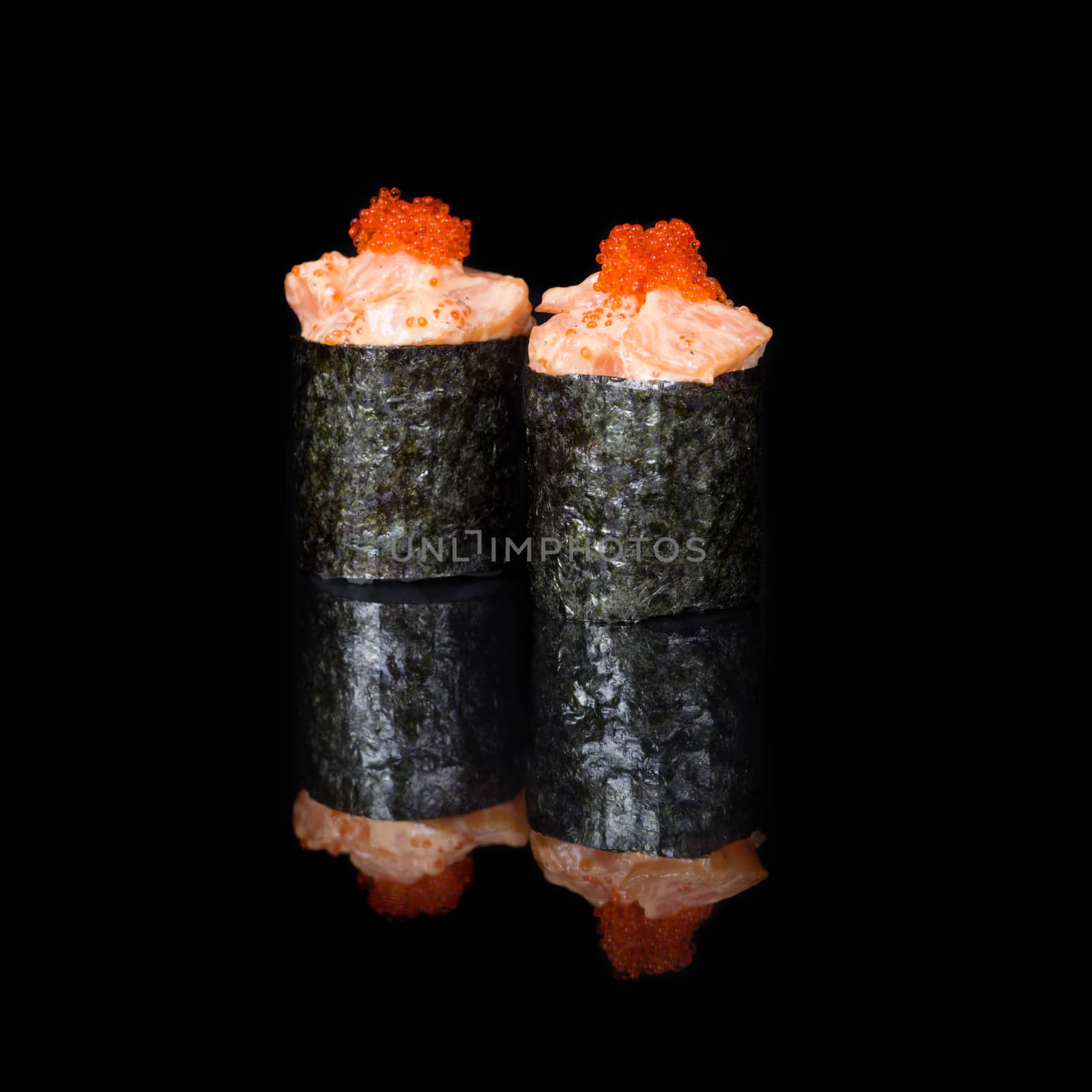 Vertical roll with salmon and caviar on black background