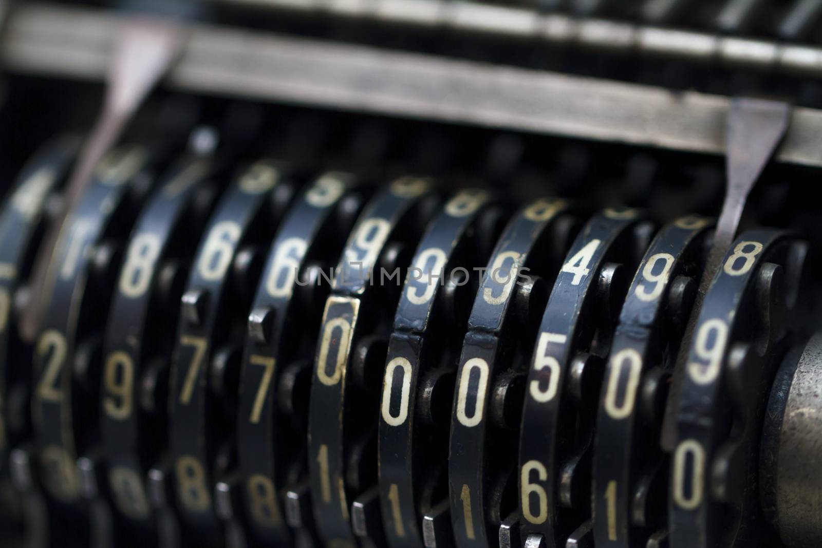 Close up detailed view of historical old calculator with small iron buttons.