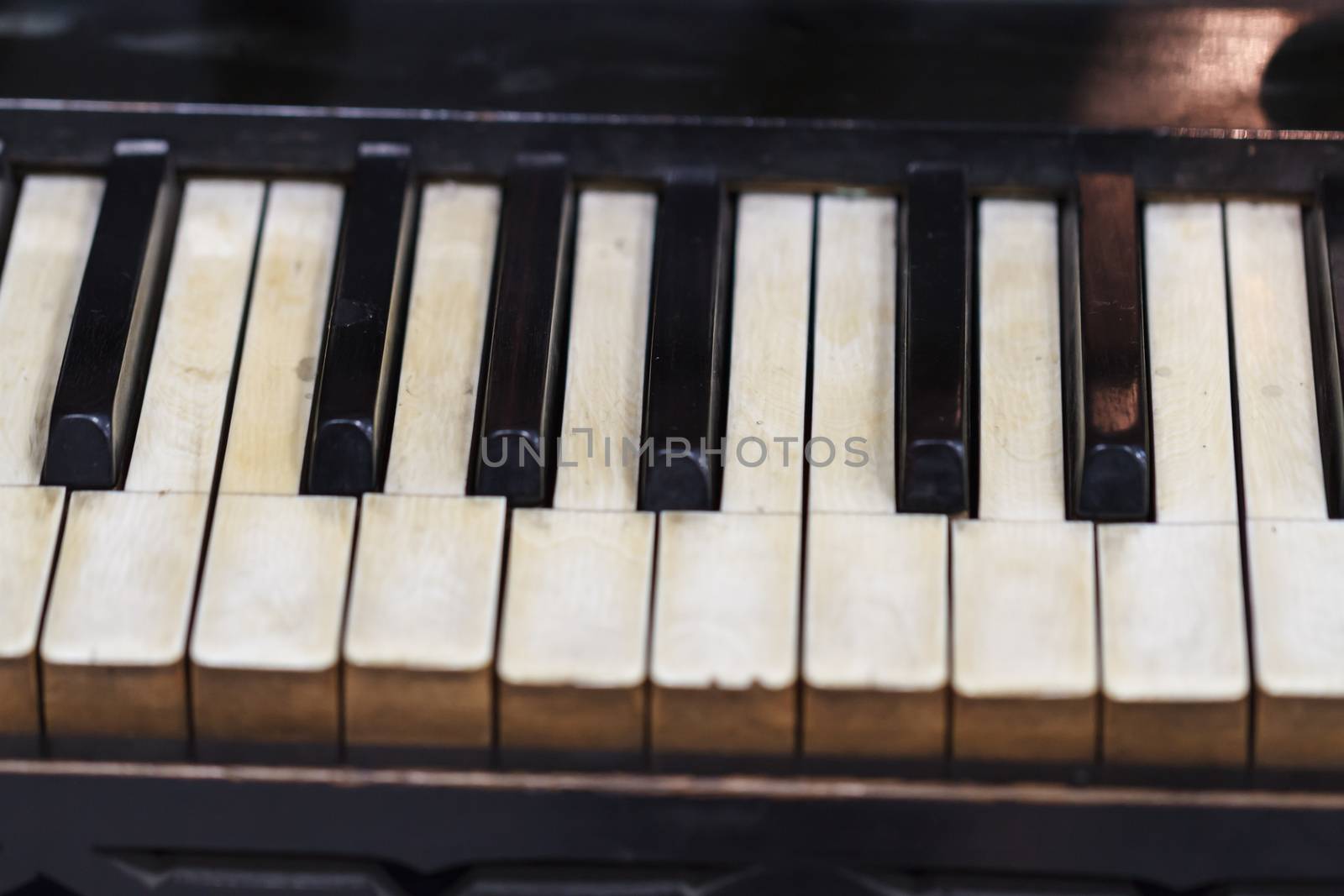 Close up detailed view of historical old piano with white and black buttons.