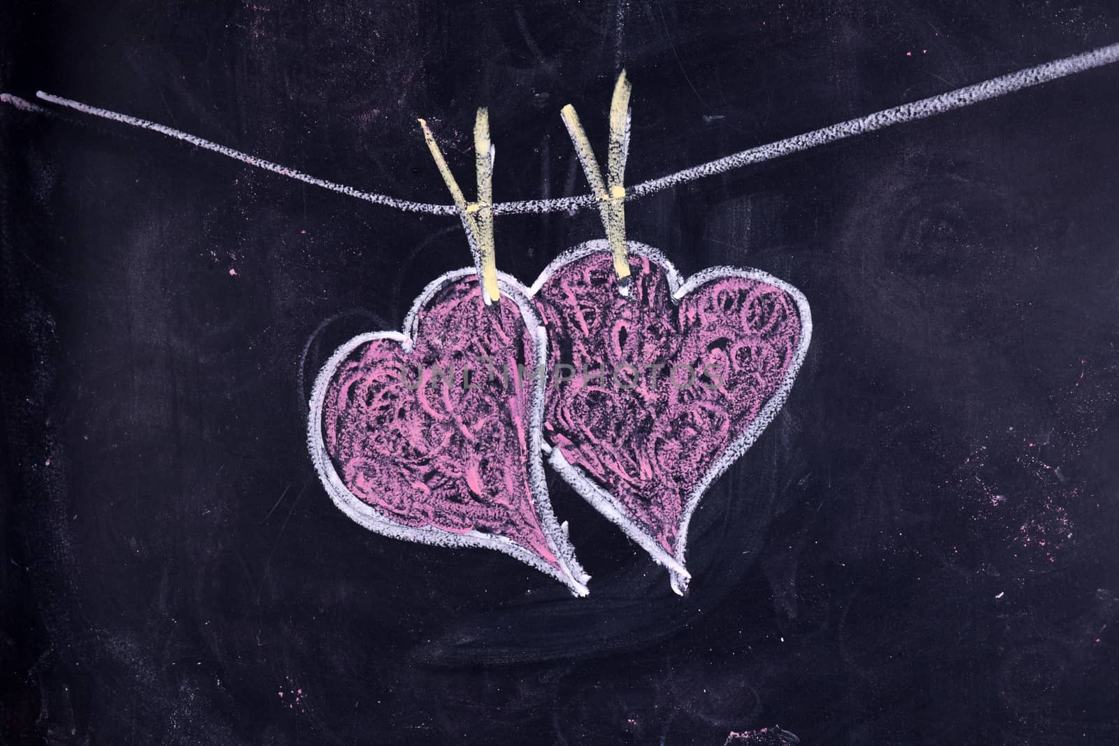 Done graphical representation with chalk on blackboard symbol of love, the heart