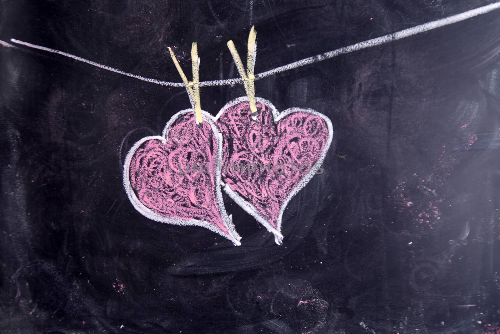 Done graphical representation with chalk on blackboard symbol of love, the heart