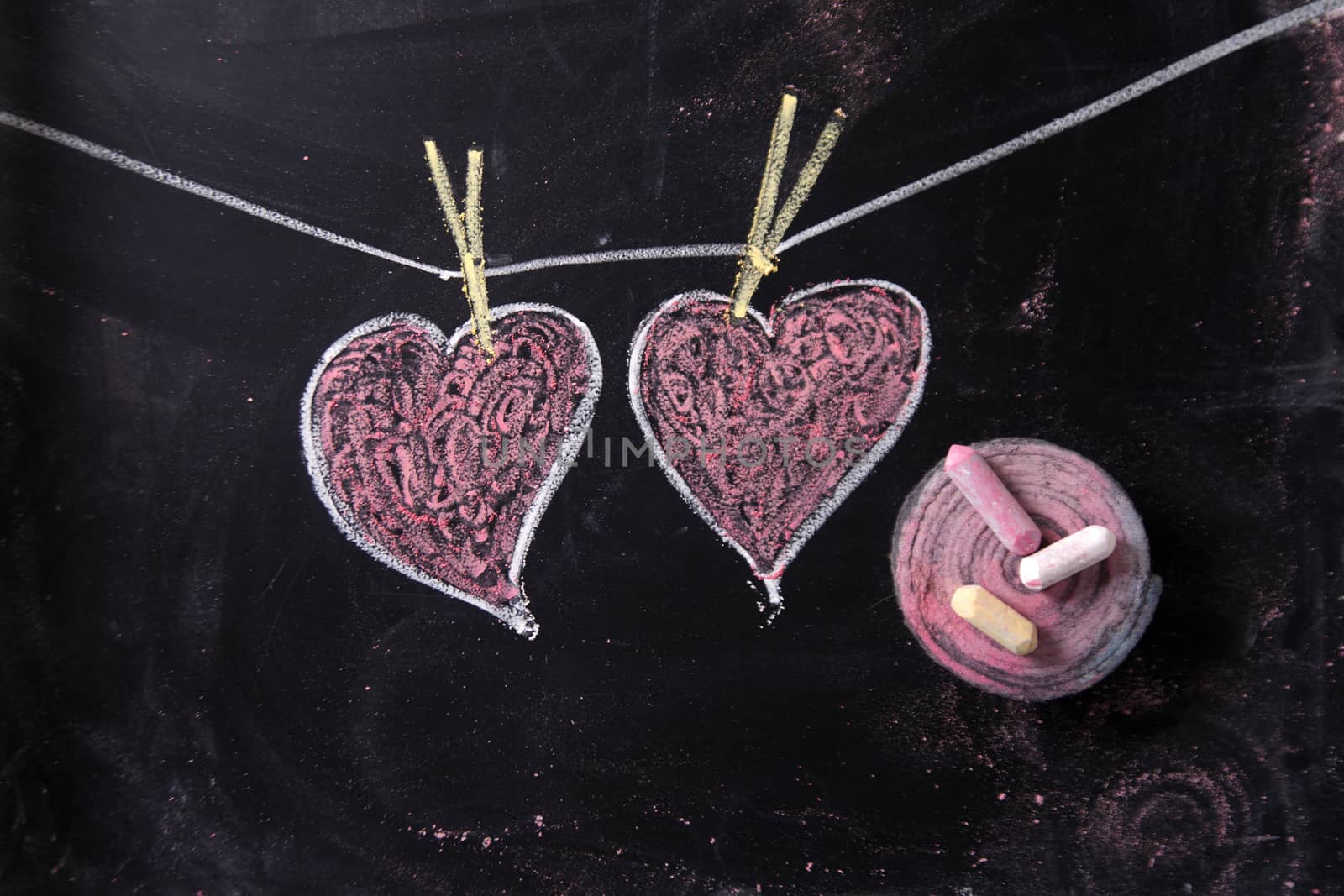 Done graphical representation with chalk on blackboard symbol of love, the heart