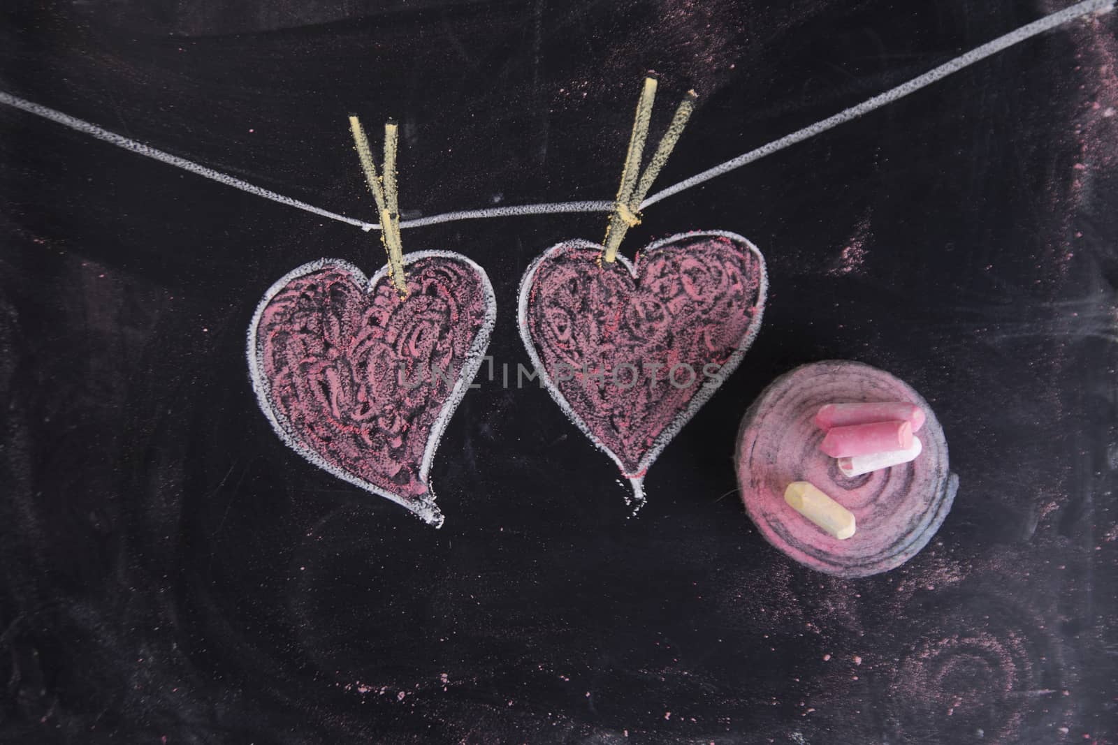 Done graphical representation with chalk on blackboard symbol of love, the heart