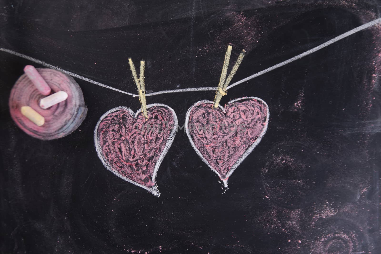 Done graphical representation with chalk on blackboard symbol of love, the heart