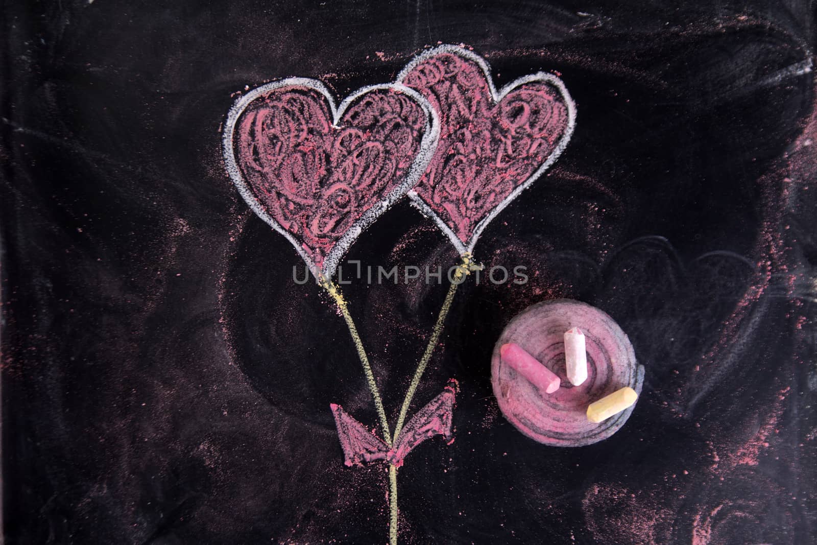 Done graphical representation with chalk on blackboard symbol of love, the heart