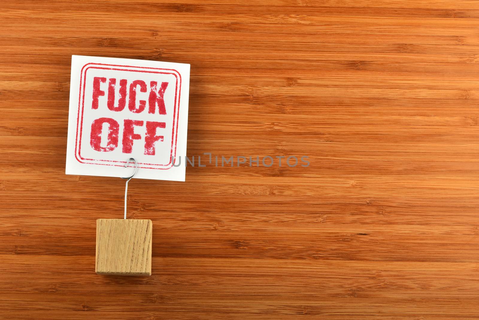 Fuck off paper note on bamboo wooden background by BreakingTheWalls