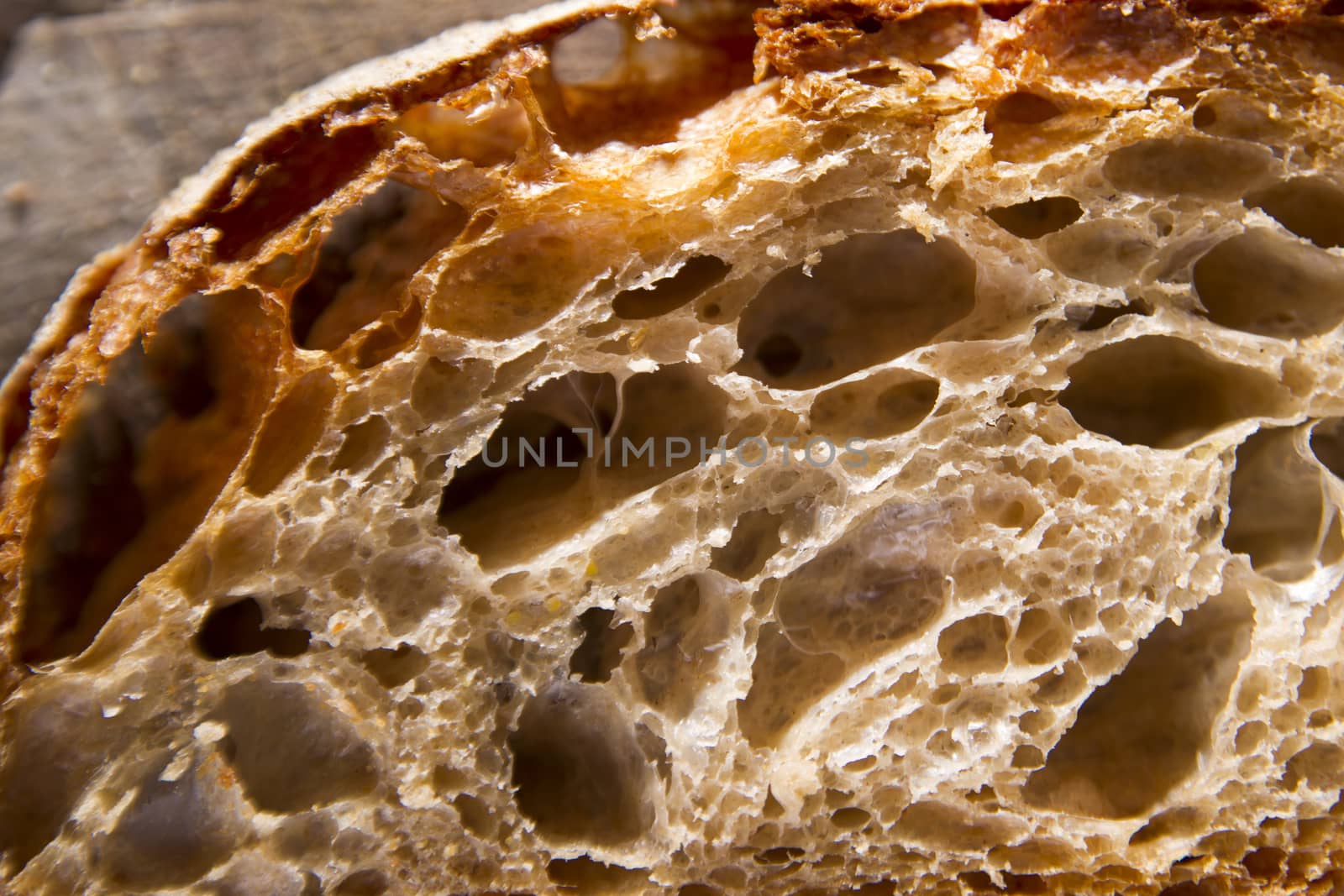 Slice of whole wheat bread on sourdough-border cooked in a wood oven