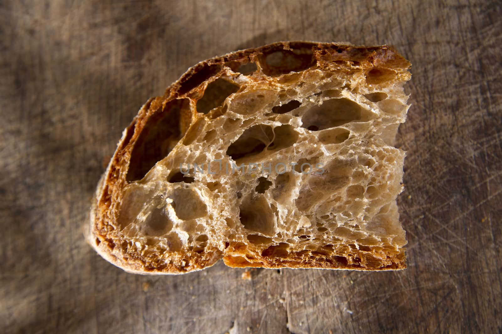 Slice of whole wheat bread on sourdough-border cooked in a wood oven