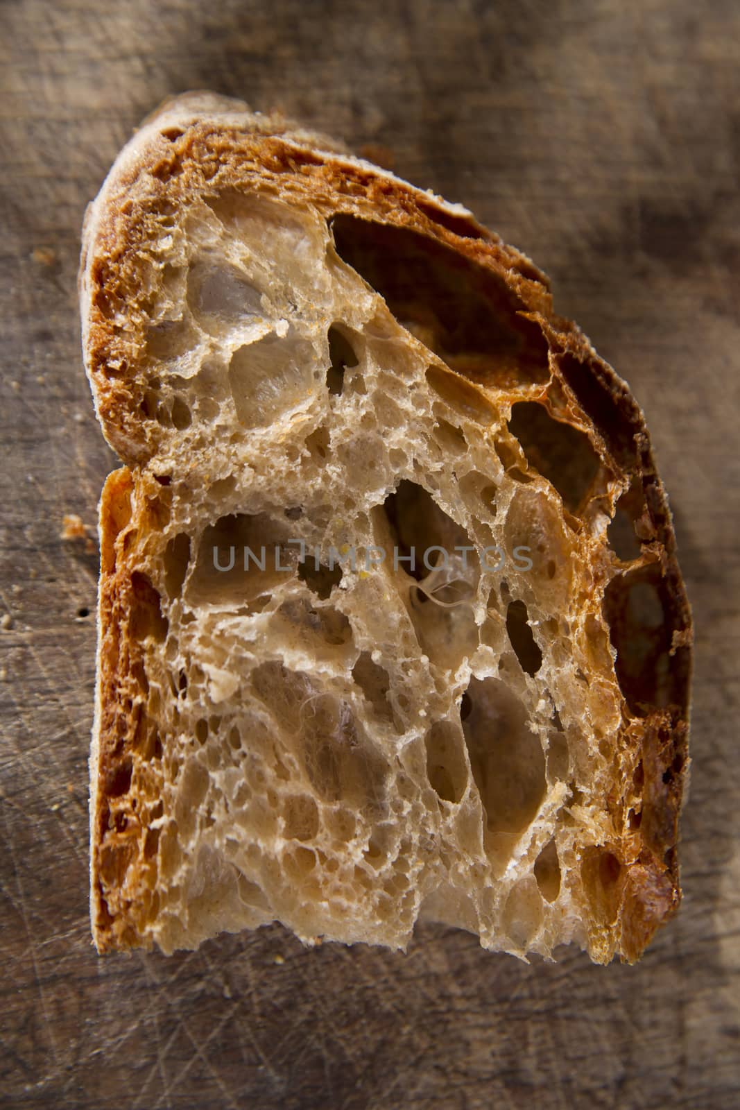 Slice of whole wheat bread on sourdough-border cooked in a wood oven