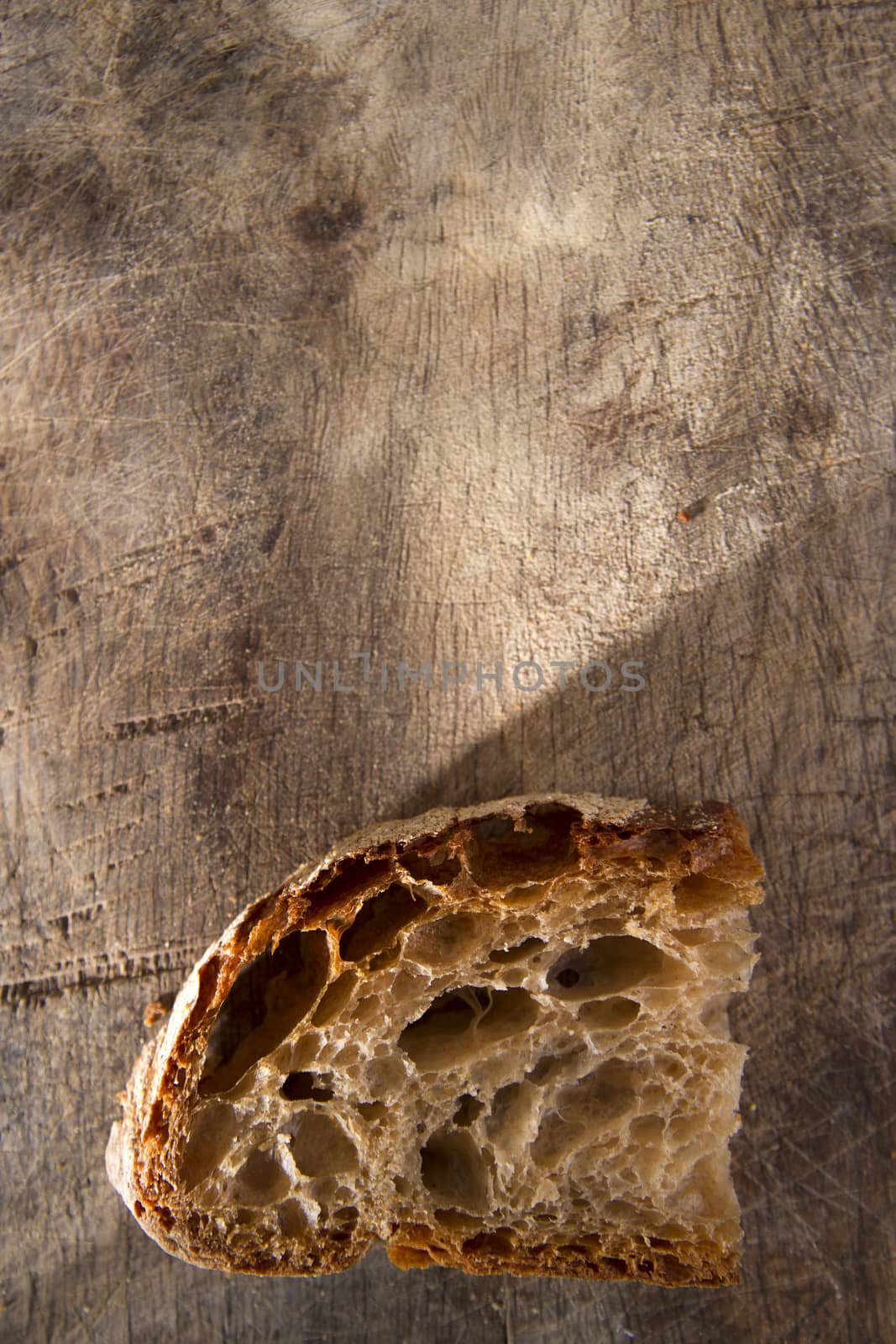 Slice of whole wheat bread on sourdough-border cooked in a wood oven