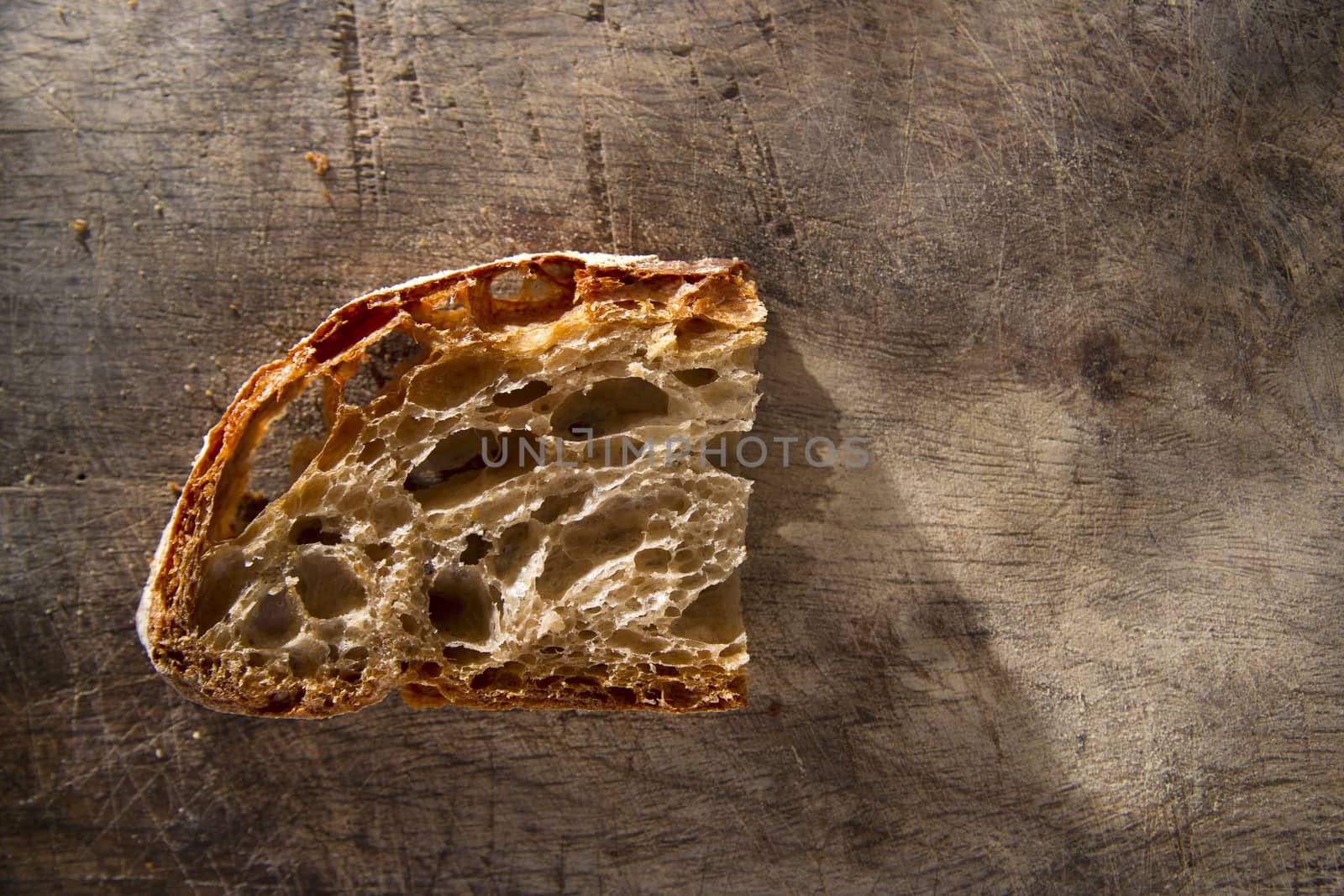 Slice of whole wheat bread on sourdough-border cooked in a wood oven