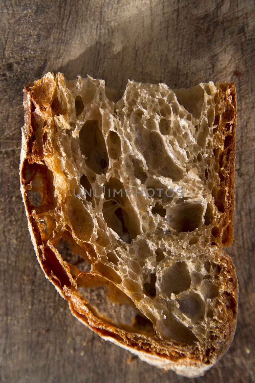 Slice of whole wheat bread on sourdough-border cooked in a wood oven