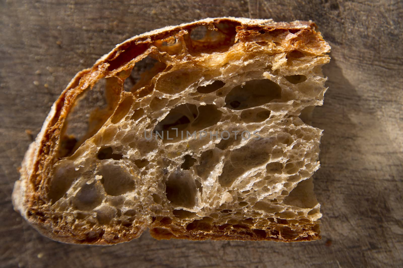 Slice of whole wheat bread on sourdough-border cooked in a wood oven