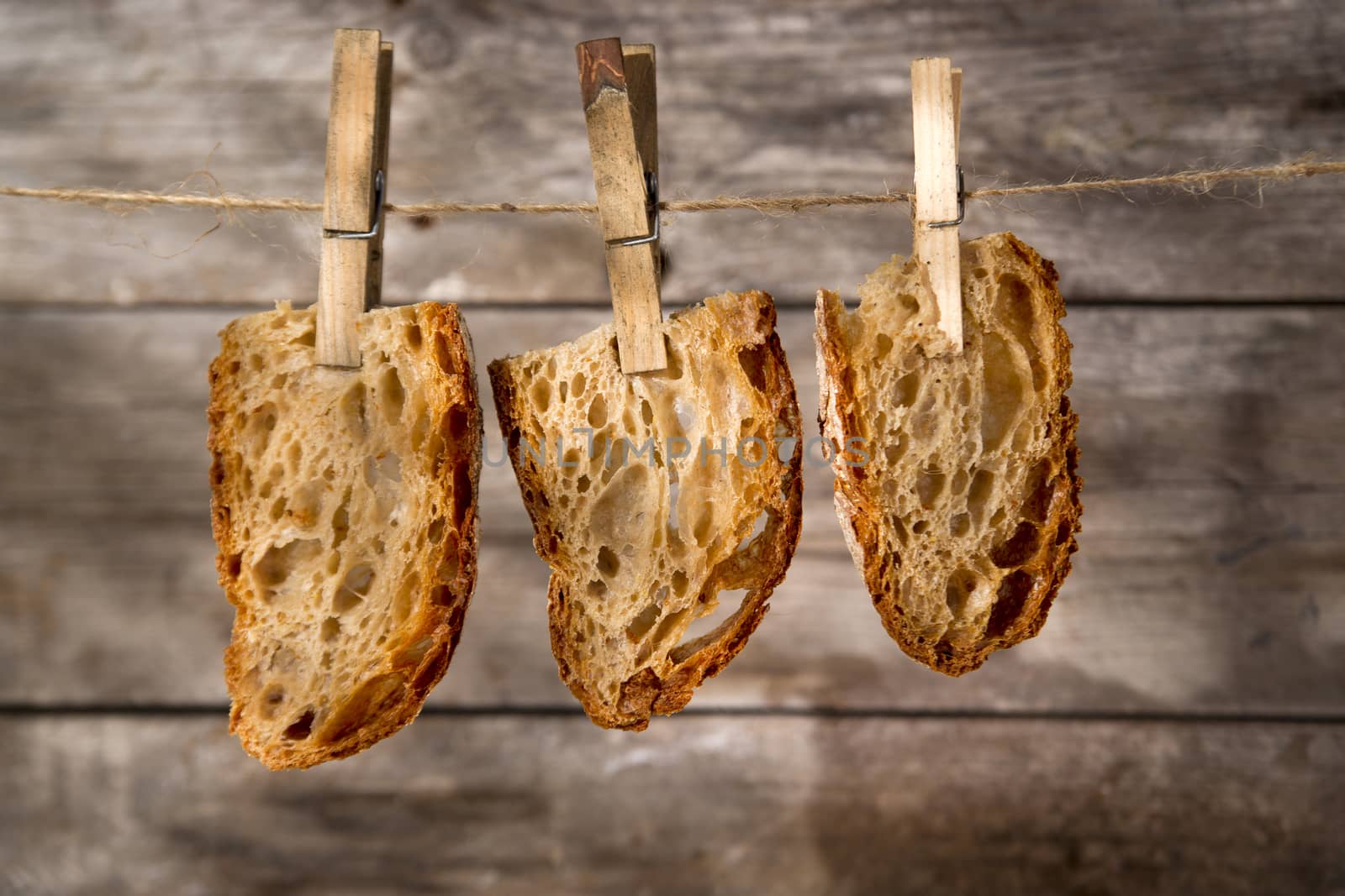 Slice of whole wheat bread sourdough baked in a wood oven hanging

