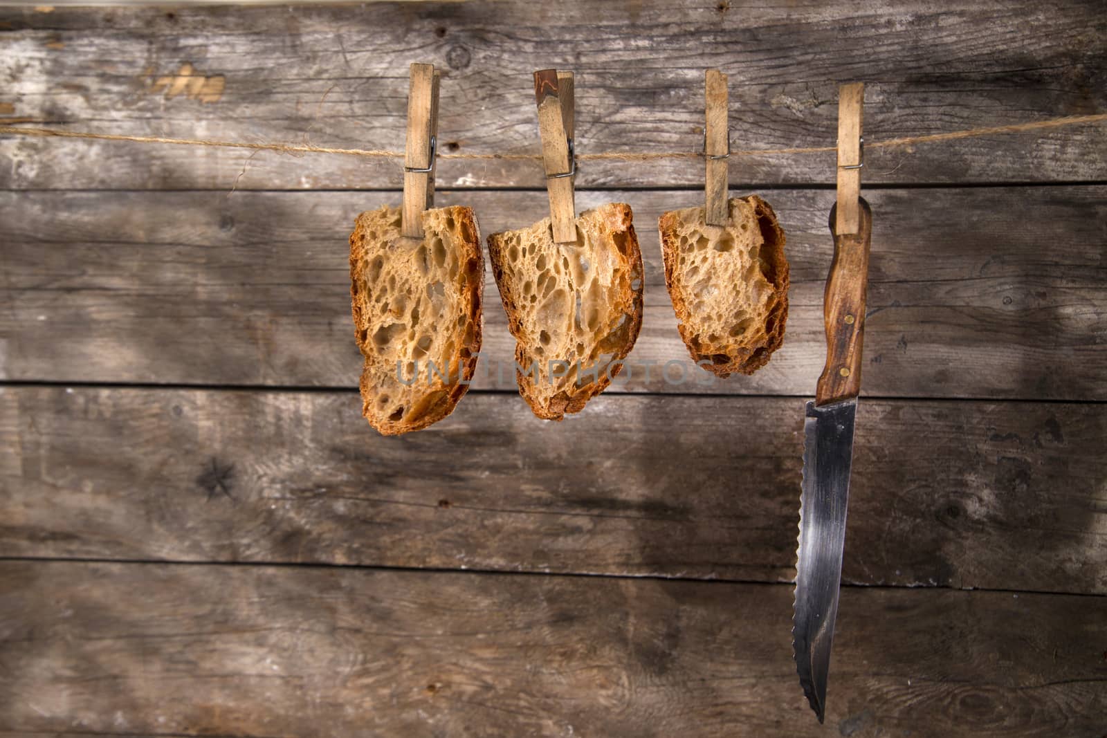 Slice of whole wheat bread sourdough baked in a wood oven hanging

