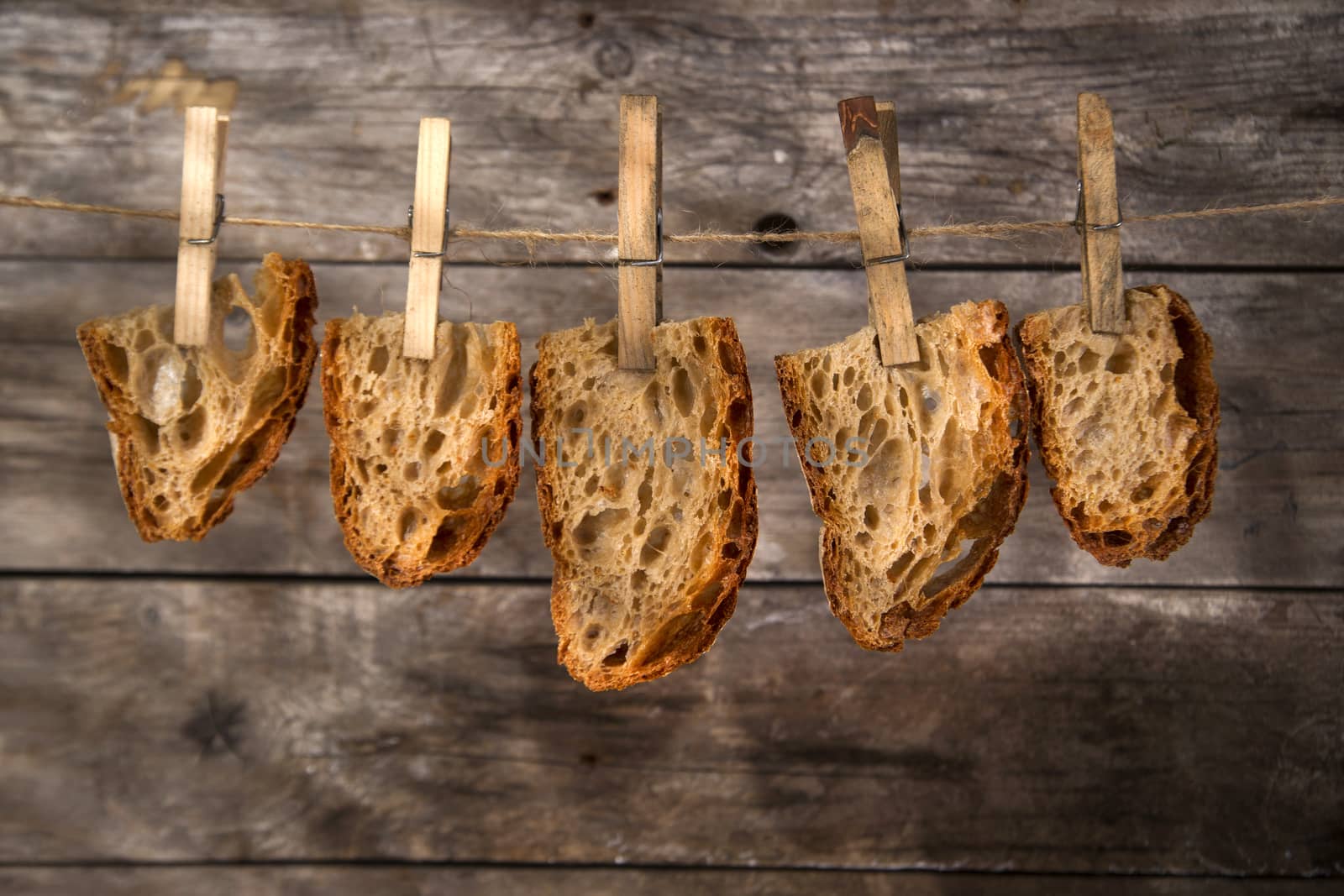 Slice of whole wheat bread sourdough baked in a wood oven hanging