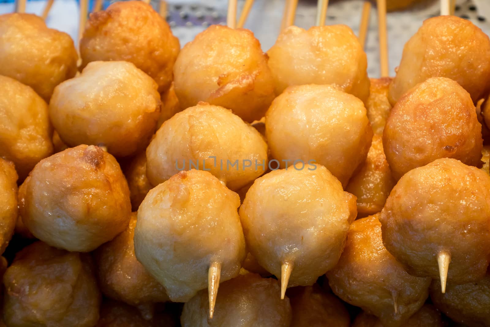 The close up of Taiwanese fried fish balls on stick at food street market in Taipei, Taiwan.