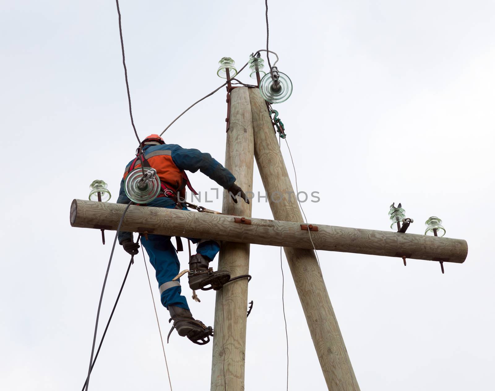 electrician working on the power lines after the accident
 with the use of special tools
