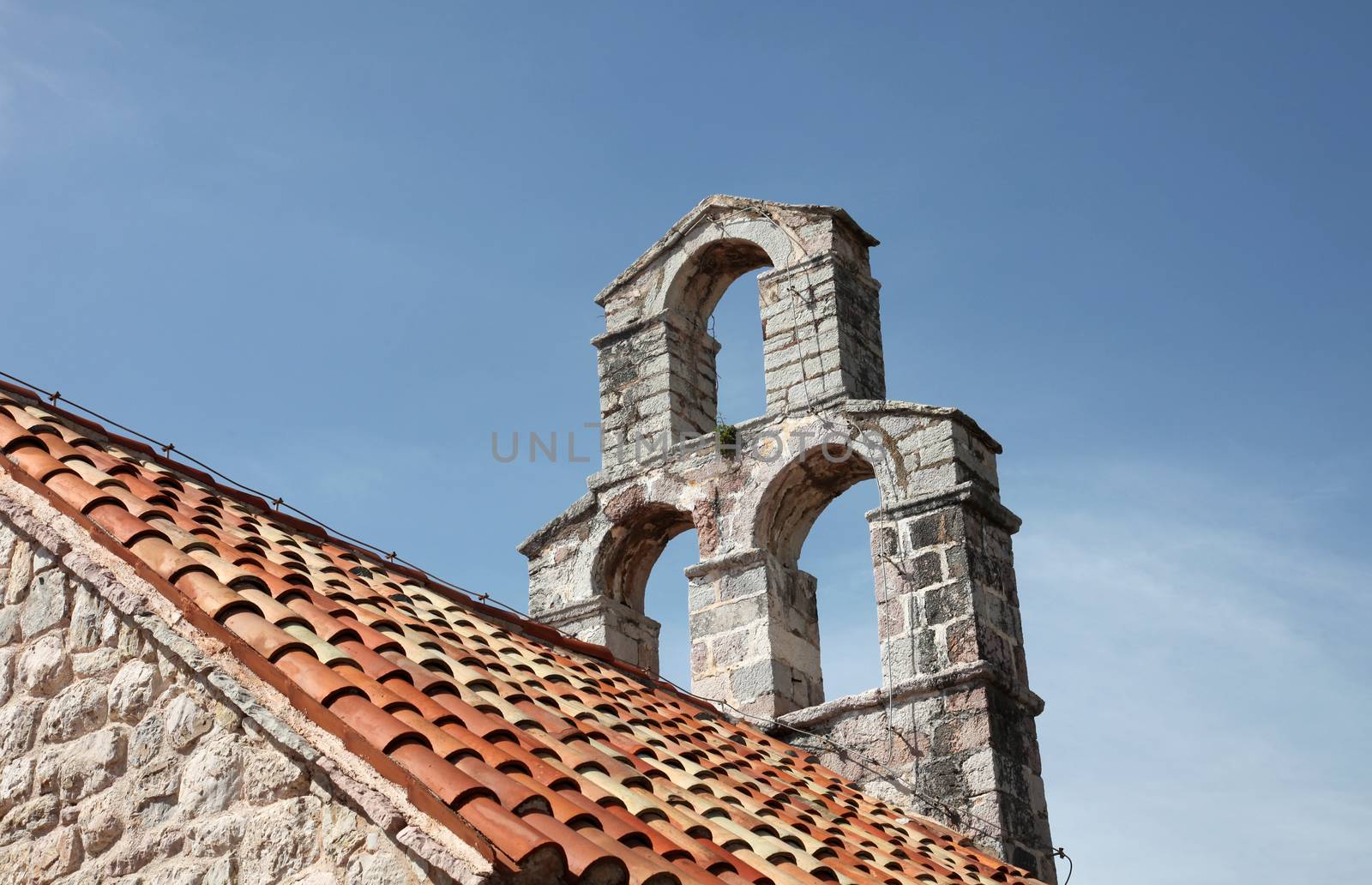The bell tower of the church of Saint Mary in Punta, Budva, Montenegro by atlas