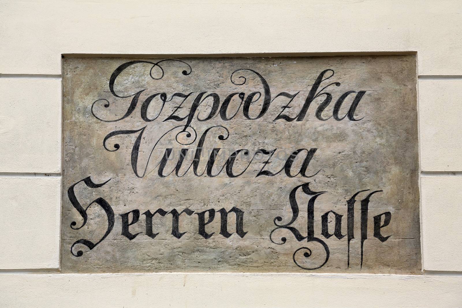 Ancient street name sign in the Upper Town of Zagreb, Croatia. Restorers have uncovered archaic bilingual street names long hidden under layers of plaster.