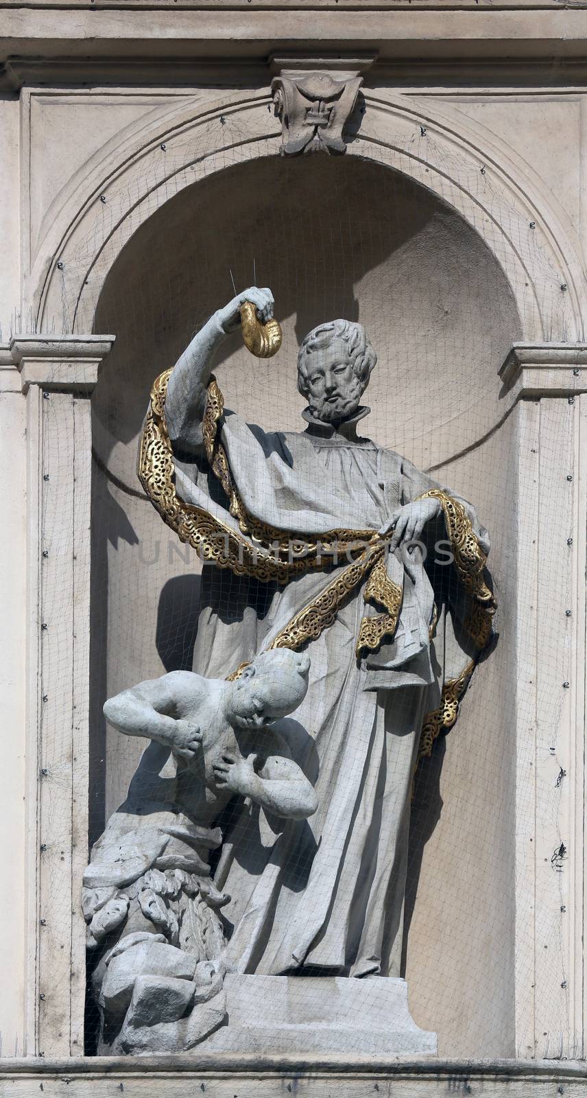 Statue of Saint on baroque Jesuits church. The church was built between 1623 and 1627. in Vienna, Austria