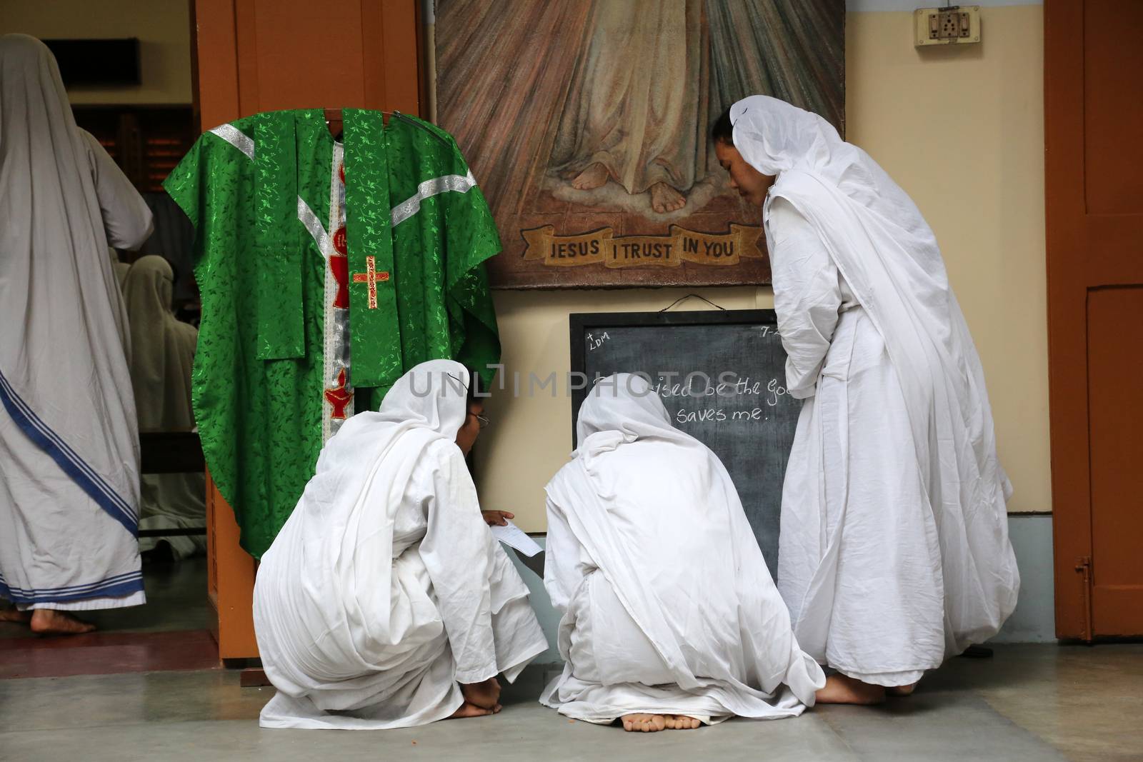 Sister of Missionaries of Charity preparing for prayer in Motherhouse, Kolkata by atlas