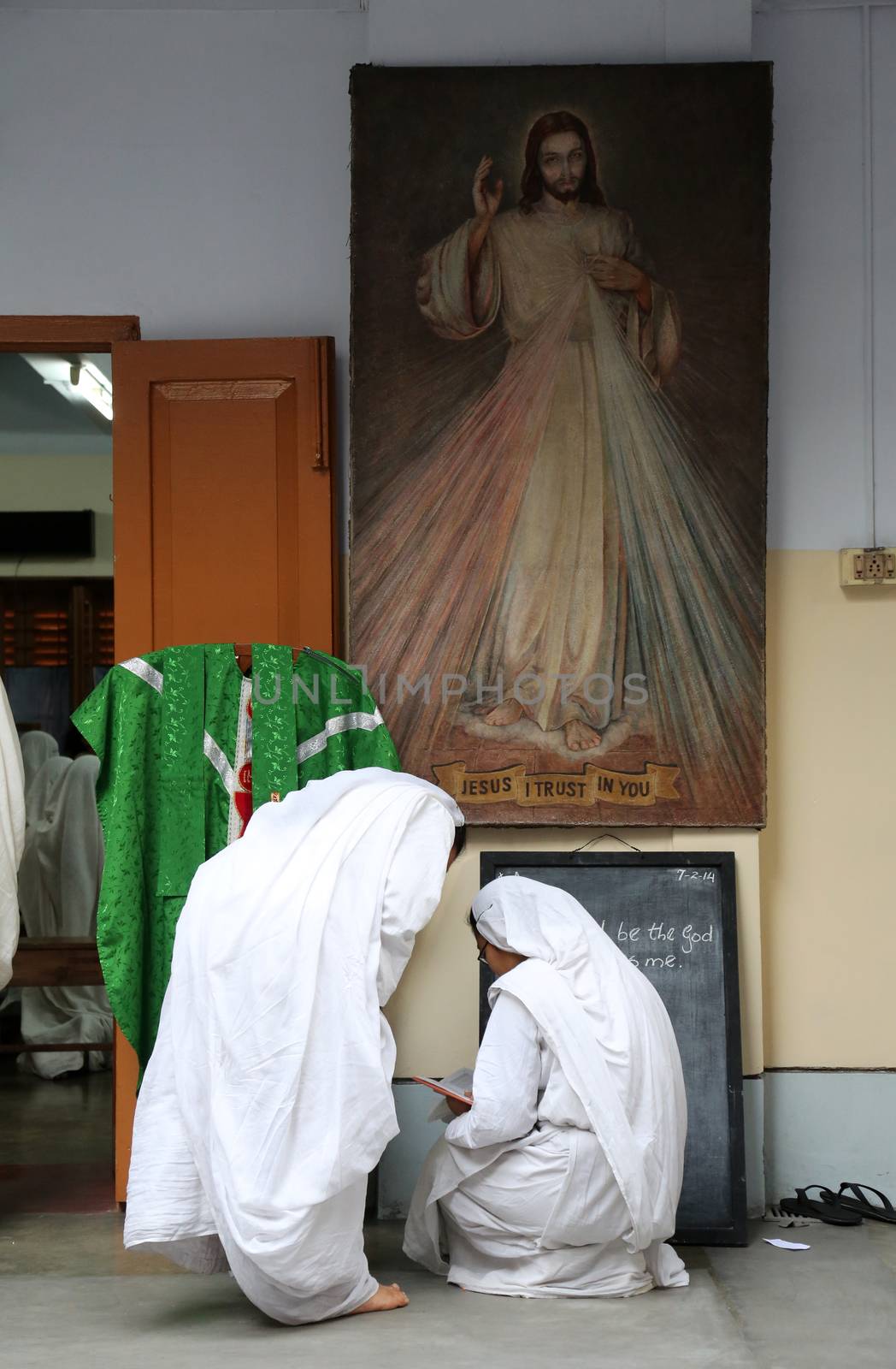 Sister of Missionaries of Charity preparing for prayer in Motherhouse, Kolkata by atlas