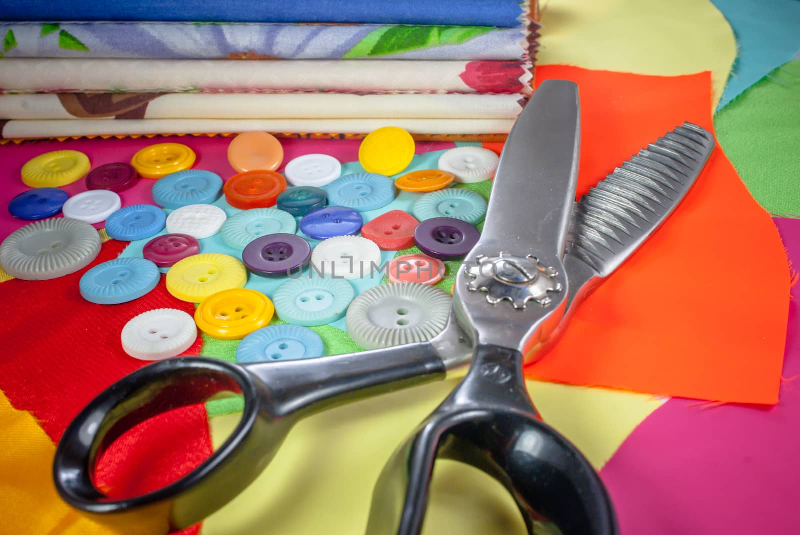 background with sewing accessories, with colored chintz, buttons, serrated shears, set for needlework by uvisni