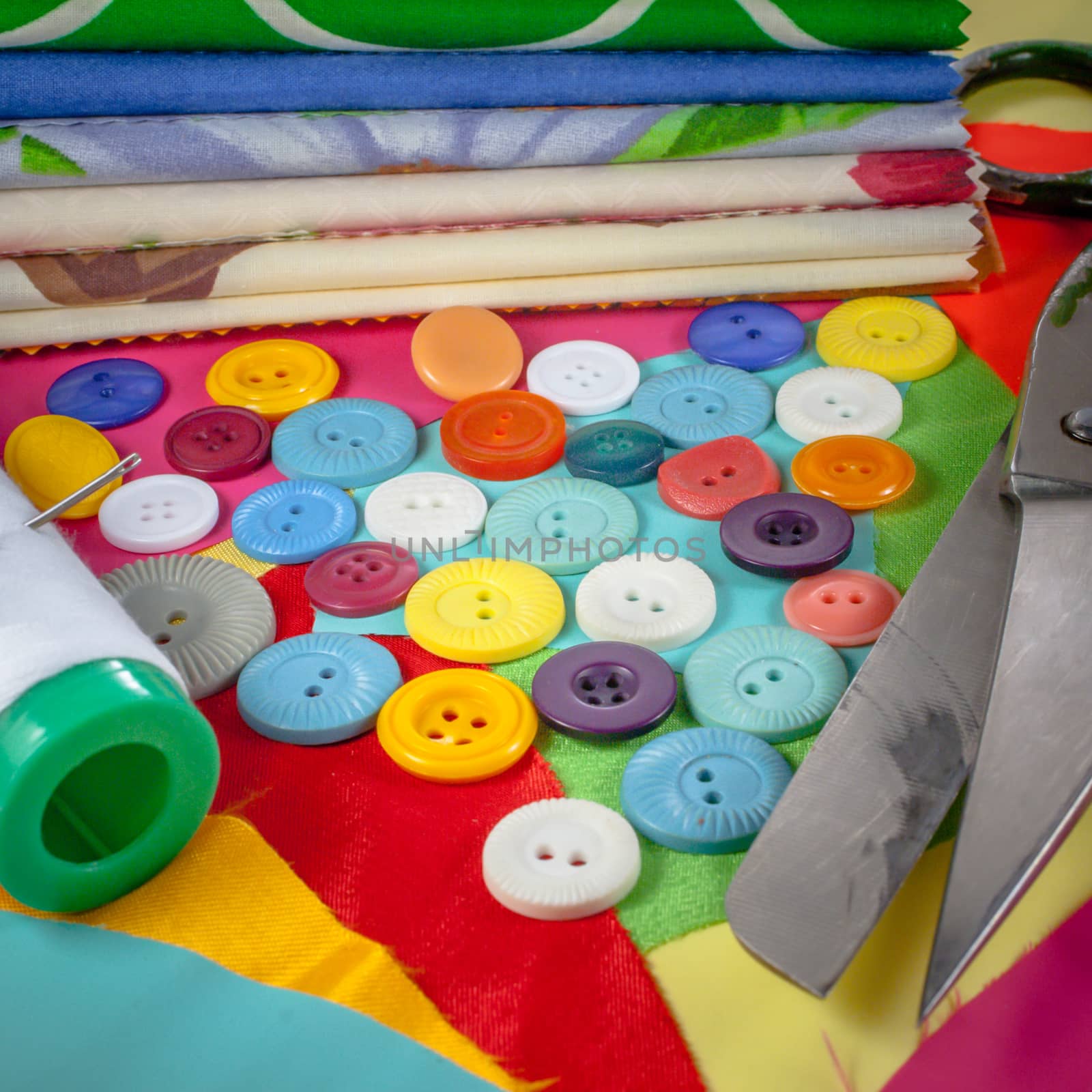 background with sewing accessories, with colored chintz, buttons, shears, set for needlework by uvisni