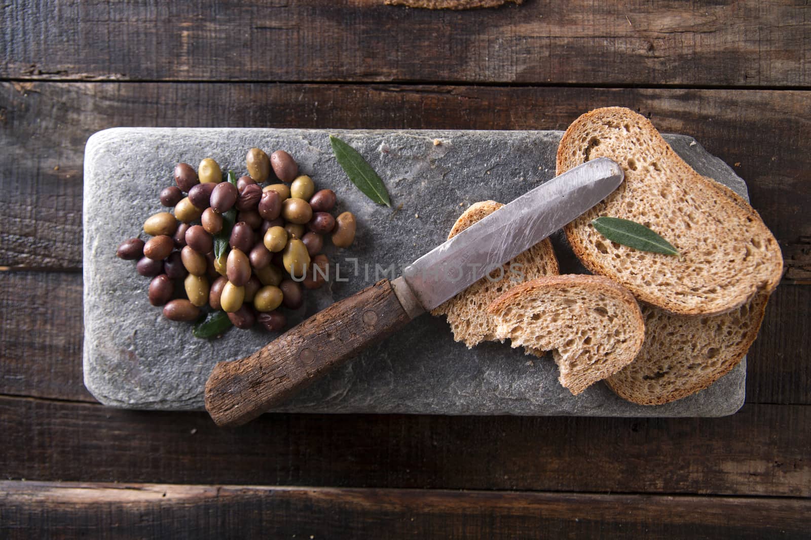 Aperitif made of bread with mixed olives in brine of Tuscany Italy
