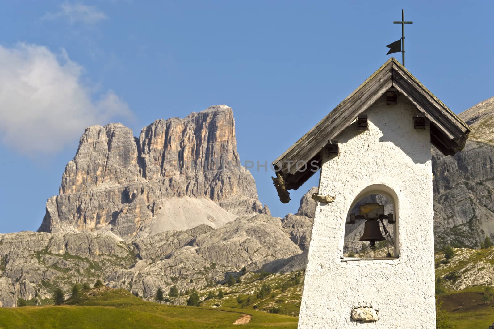 bell tower with landscape of the italians mountains background in a summer day, Dolomiti - Italy