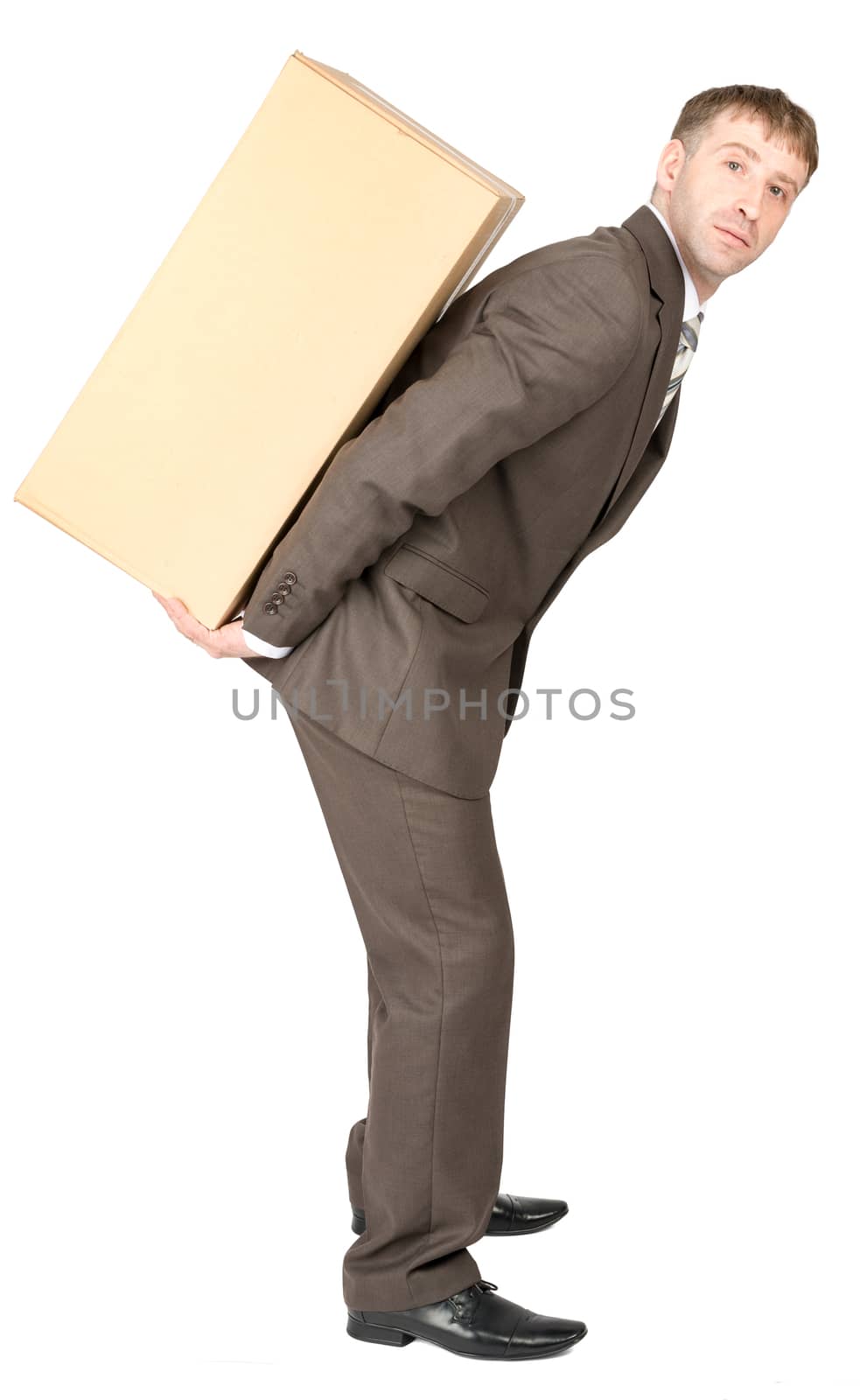 Tired young businessman carrying heavy box on back. Isolated on white background