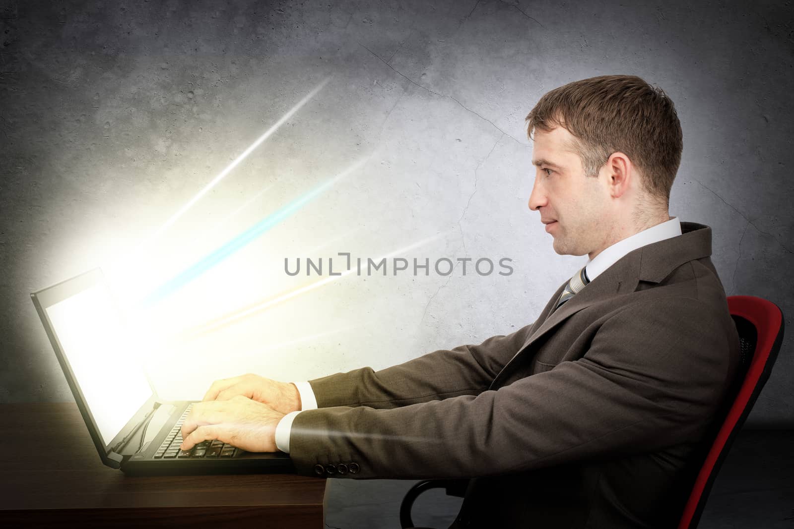 Businessman with laptop. E-business concept by cherezoff
