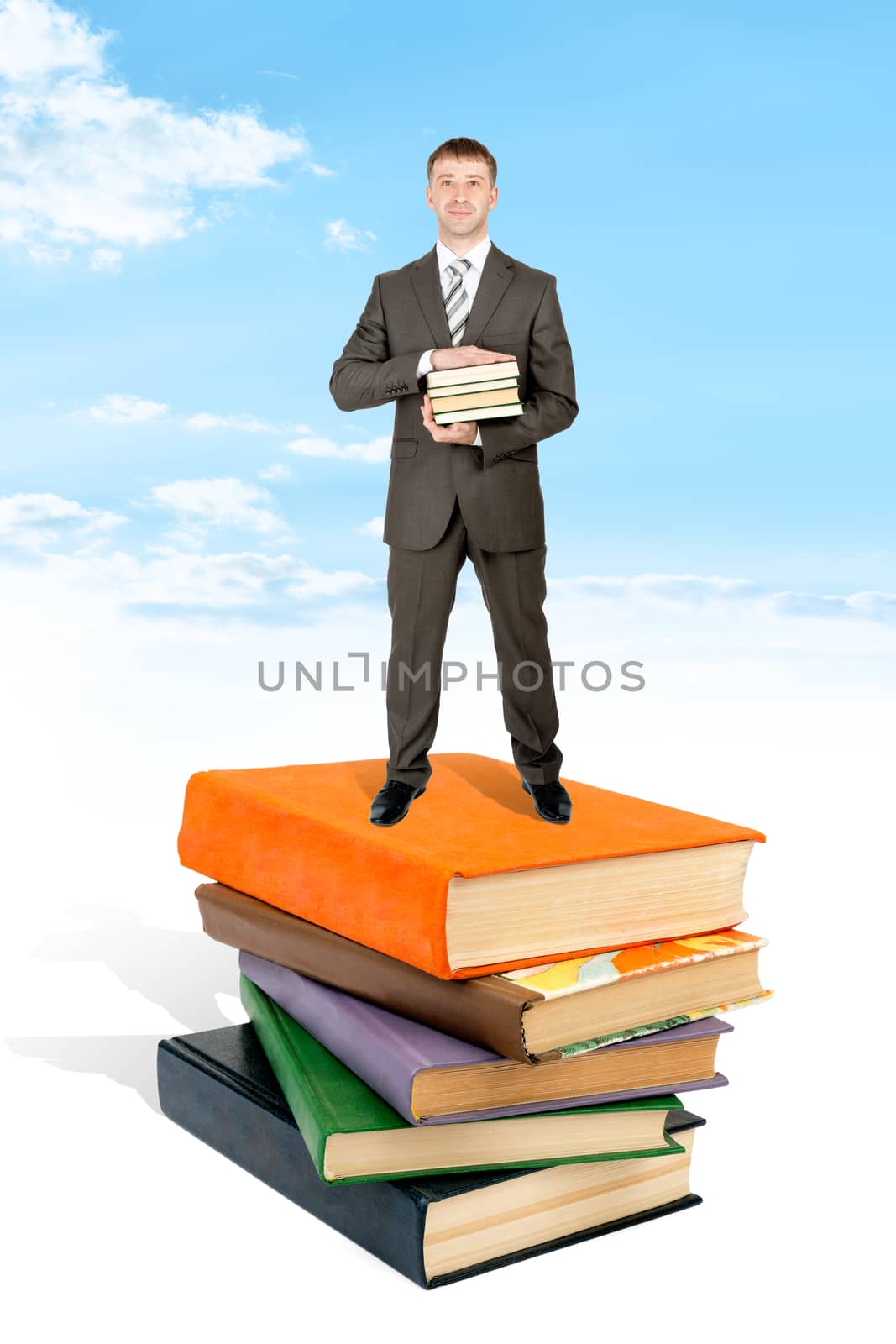 Man stand on pile of book and hold books. Blue sky and cloud at background