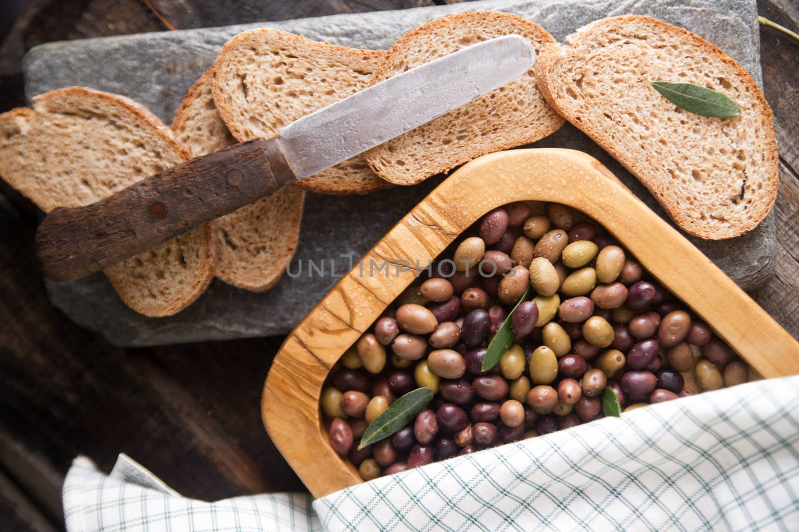 Aperitif made of bread with mixed olives in brine of Tuscany Italy
