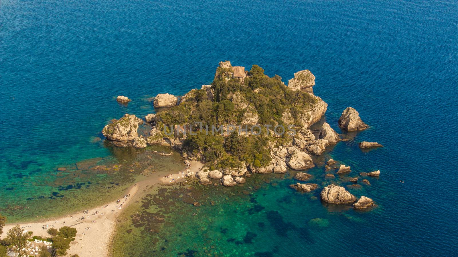 Aerial view of Isola Bella's island and beach on blue ocean water in Taormina - Sicily.