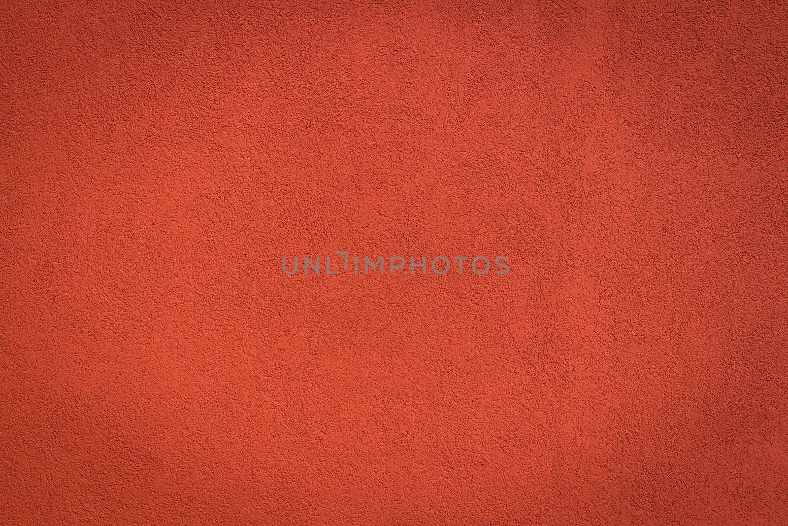 Red wall background and texture with vignetting and blank copyspace for text or advertising.